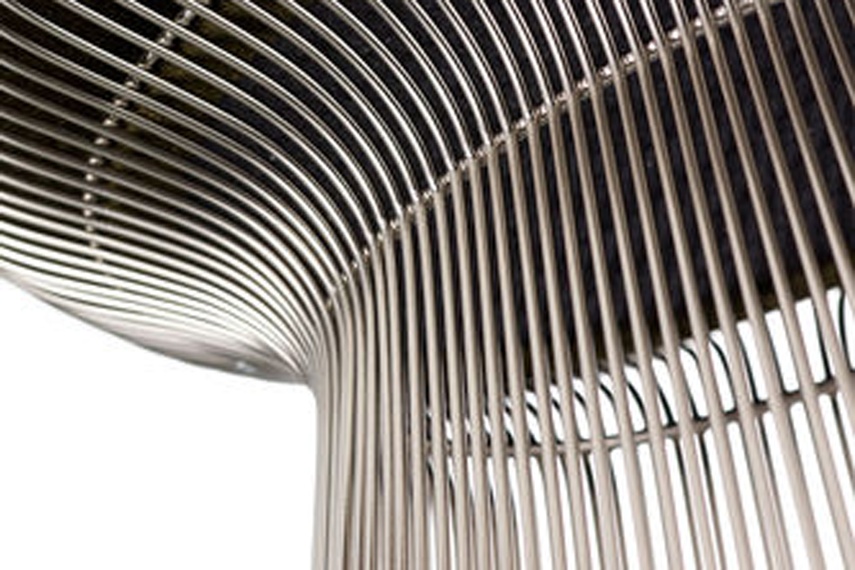 The chairs are created by welding hundreds of curved, nickel-plated steel rods to circular frames