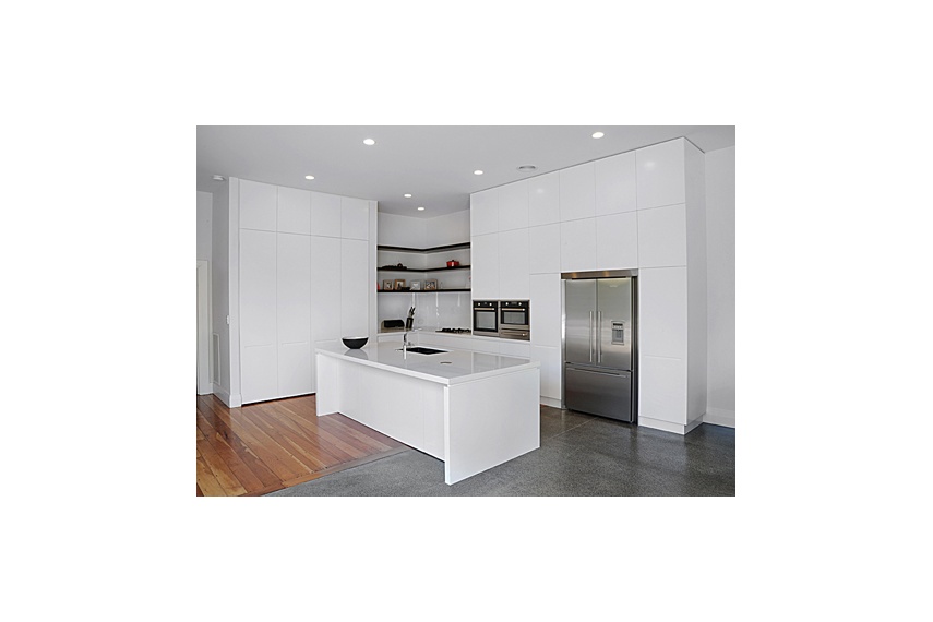 Mt Eden Kitchen – sleek white cabinetry and a stud height of 3.6m conceals a wealth of storage space